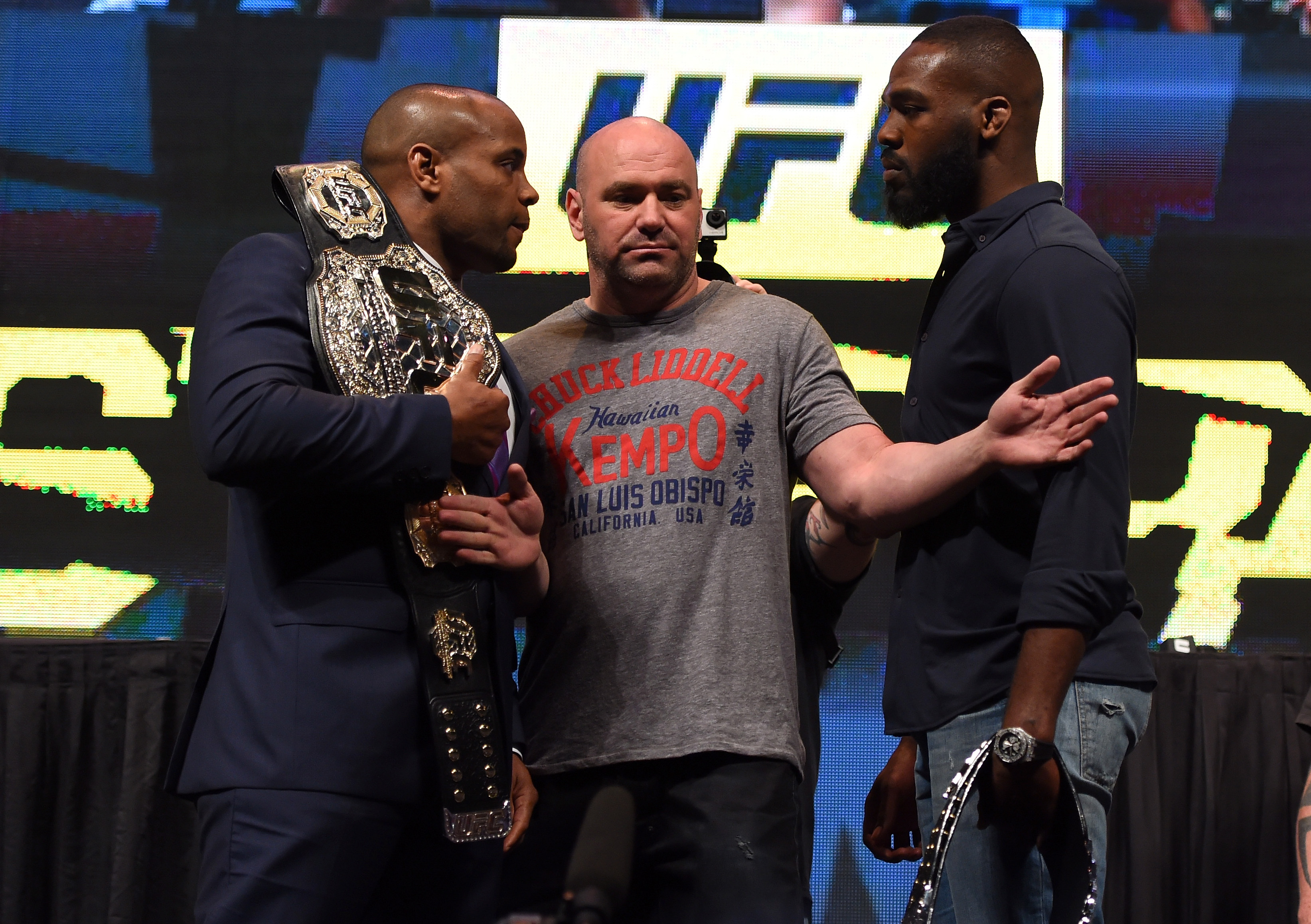 UFC president holds Daniel Cormier and Jon Jones back from one another during a media event. (Getty)