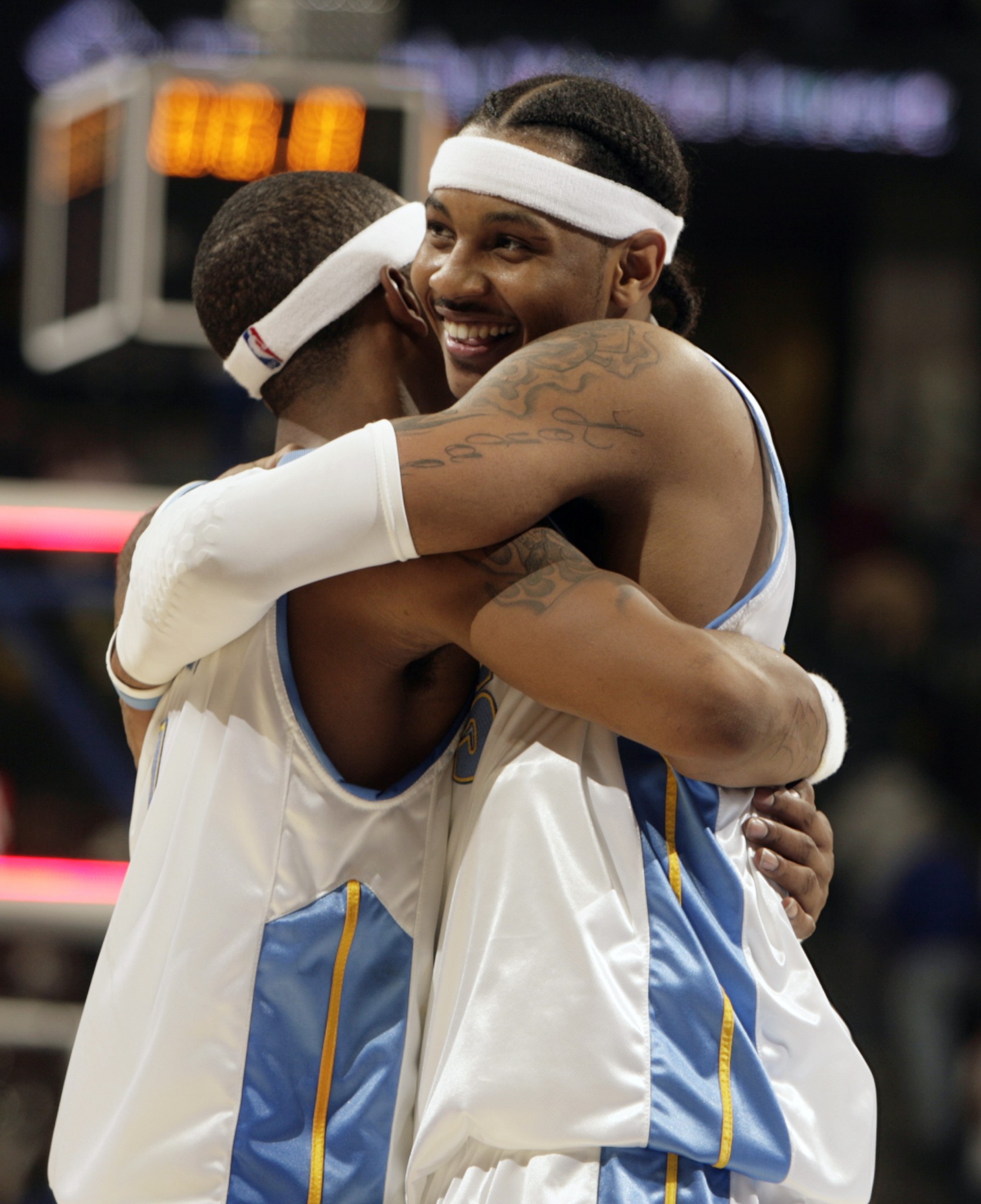 J.R. Smith (left) is enveloped by Carmelo Anthony in 2006. (AP/David Zalubowski)