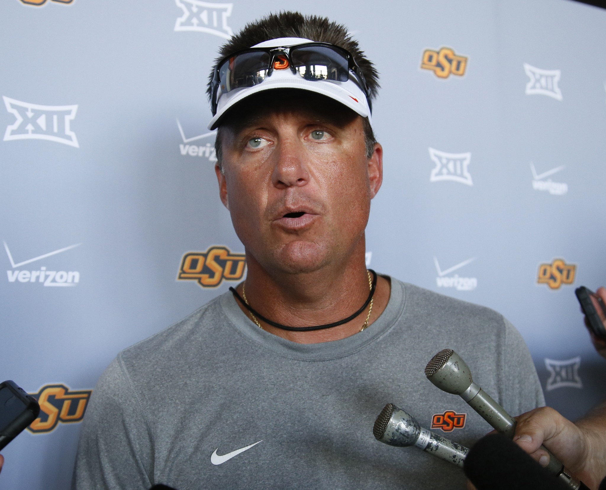 Oklahoma State head coach Mike Gundy talks with the media following an NCAA college football practice of the year in Stillwater, Okla., Tuesday, Aug. 2, 2016. (AP Photo/Sue Ogrocki)