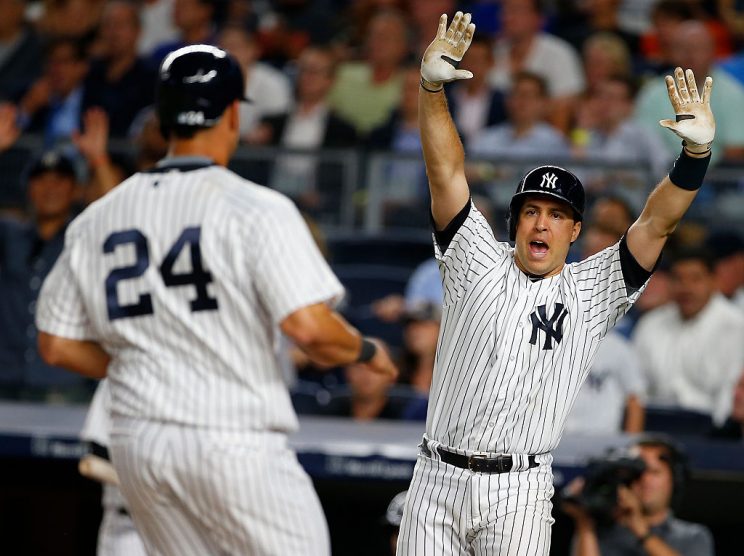 NEW YORK, NY - AUGUST 03: Mark Teixeira #25 raises his arms as Gary Sanchez #24 of the New York Yankees scores on a single by Rob Refsnyder #38 against the New York Mets during the seventh inning of a game at Yankee Stadium on August 3, 2016 in the Bronx borough of New York City. The Yankees defeated the Mets 9-5. (Photo by Rich Schultz/Getty Images)