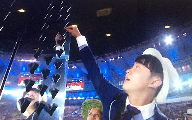 Athletes entering Maracana Stadium were given seeds to place into black cartridges hanging on large towers during the Parade of Nations.