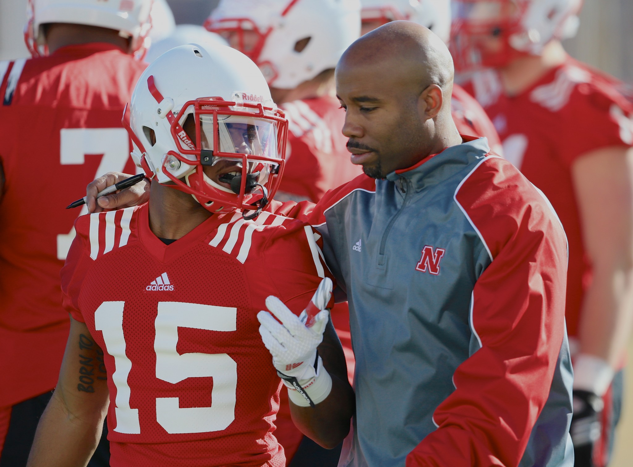 Nebraska wide receivers coach Keith Williams talks to wide receiver De'Mornay Pierson-El (15) on the first day of spring NCAA college football practice in Lincoln, Neb., Saturday, March 7, 2015. (AP Photo/Nati Harnik)