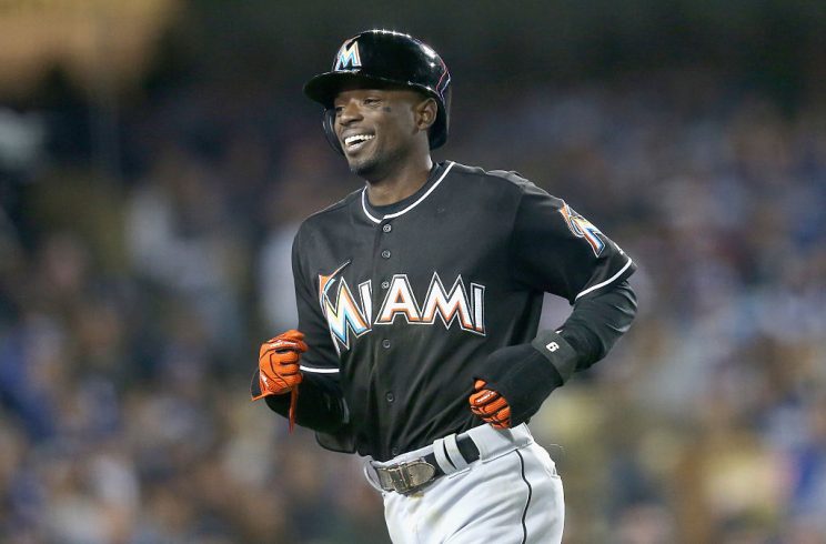 LOS ANGELES, CALIFORNIA - APRIL 28: Dee Gordon #9 of the Miami Marlins laughs as he returns to the dugout after scoring a run on a balk in the seventh inning against the Los Angeles Dodgers at Dodger Stadium on April 28, 2016 in Los Angeles, California. (Photo by Stephen Dunn/Getty Images)