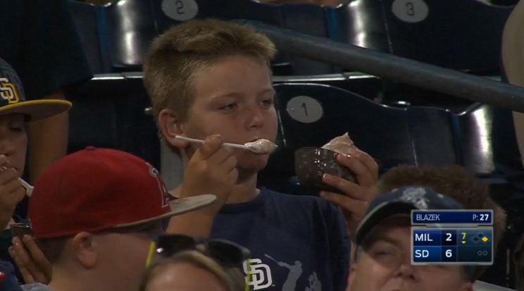 Kid at Padres game enjoys his ice cream.