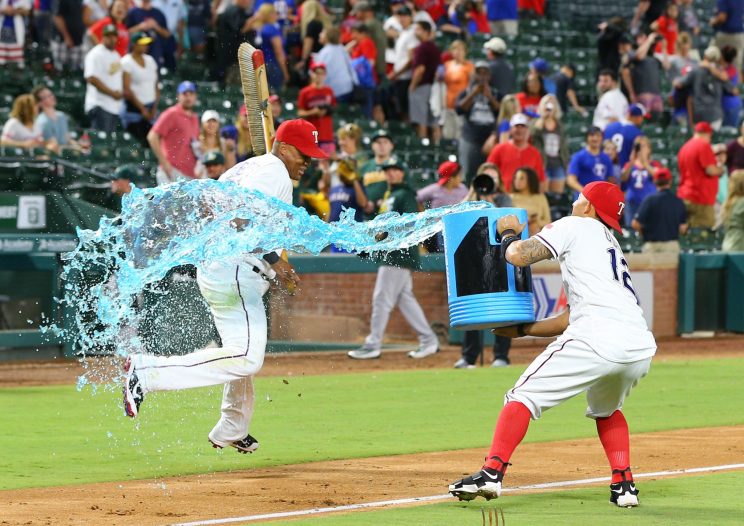 Adrian Beltre needed a broom to avoid a Gatorade bath. (Getty Images/Rick Yeatts)