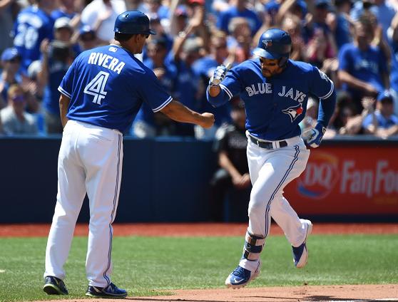 Devon Travis rounds third base after hitting a solo home run in the Blue Jays 9-1 win against the Orioles. (AP)