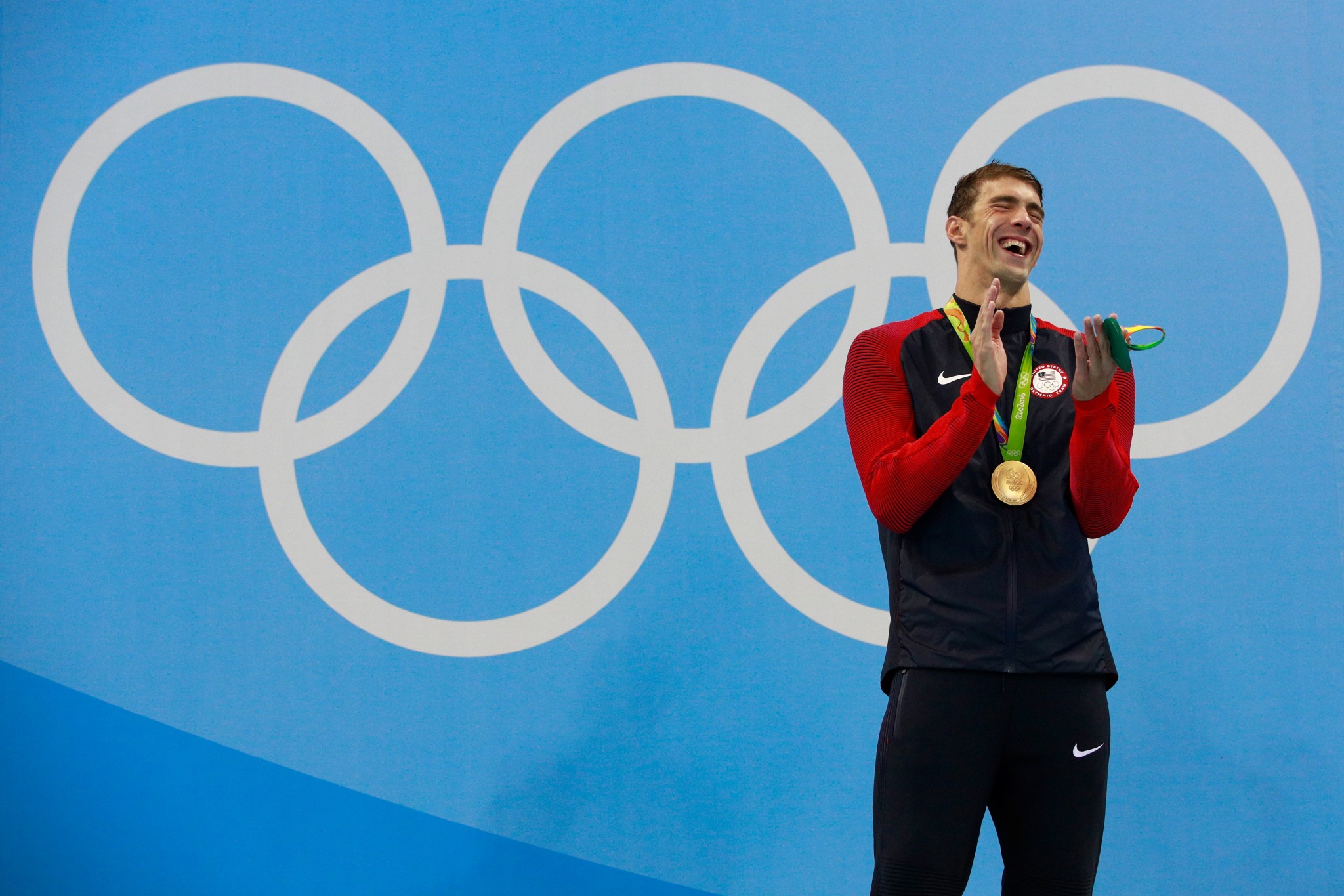Michael Phelps laughs following the playing of the national anthem. (Getty)