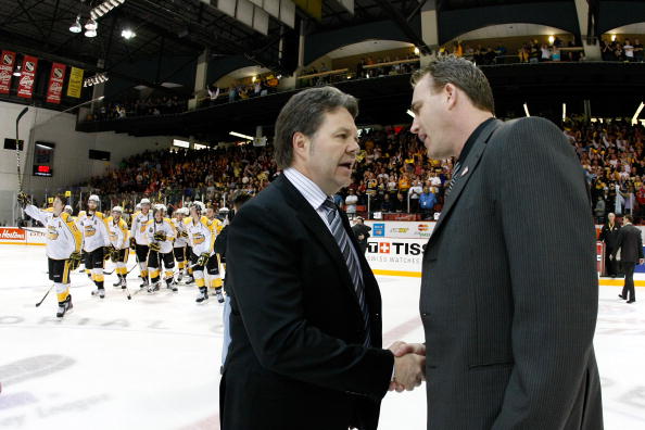 BRANDON, CANADA - MAY 21: (L-R) Brandon Wheat Kings Head Coach Kelly McCrimmon shakes hands with Calgary Hitmen Head Coach Mike Williamson after the Wheat Kings defeated the Hitmen in overtime during the 2010 Mastercard Memorial Cup Tournament at the Keystone Centre on May 21, 2010 in Brandon, Manitoba, Canada. The Wheat Kings defeated the Hitmen 5-4 in overtime. THe Wheat Kings will face the Spitfires in the Finals. (Photo by Richard Wolowicz/Getty Images)