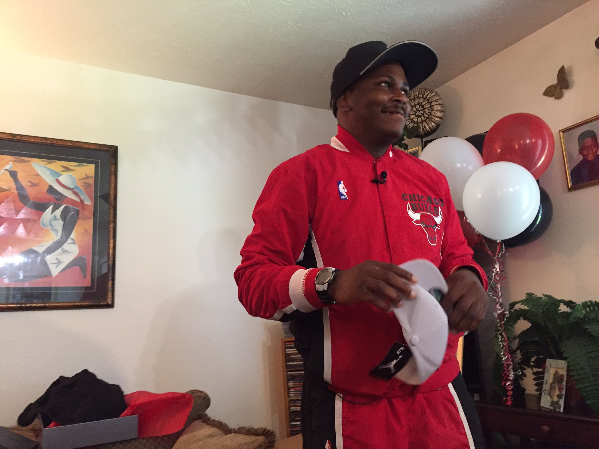 Jeffrey Harrison smiles as he opens the gifts Michael Jordan sent him. (Photo via @DarnayTripp)