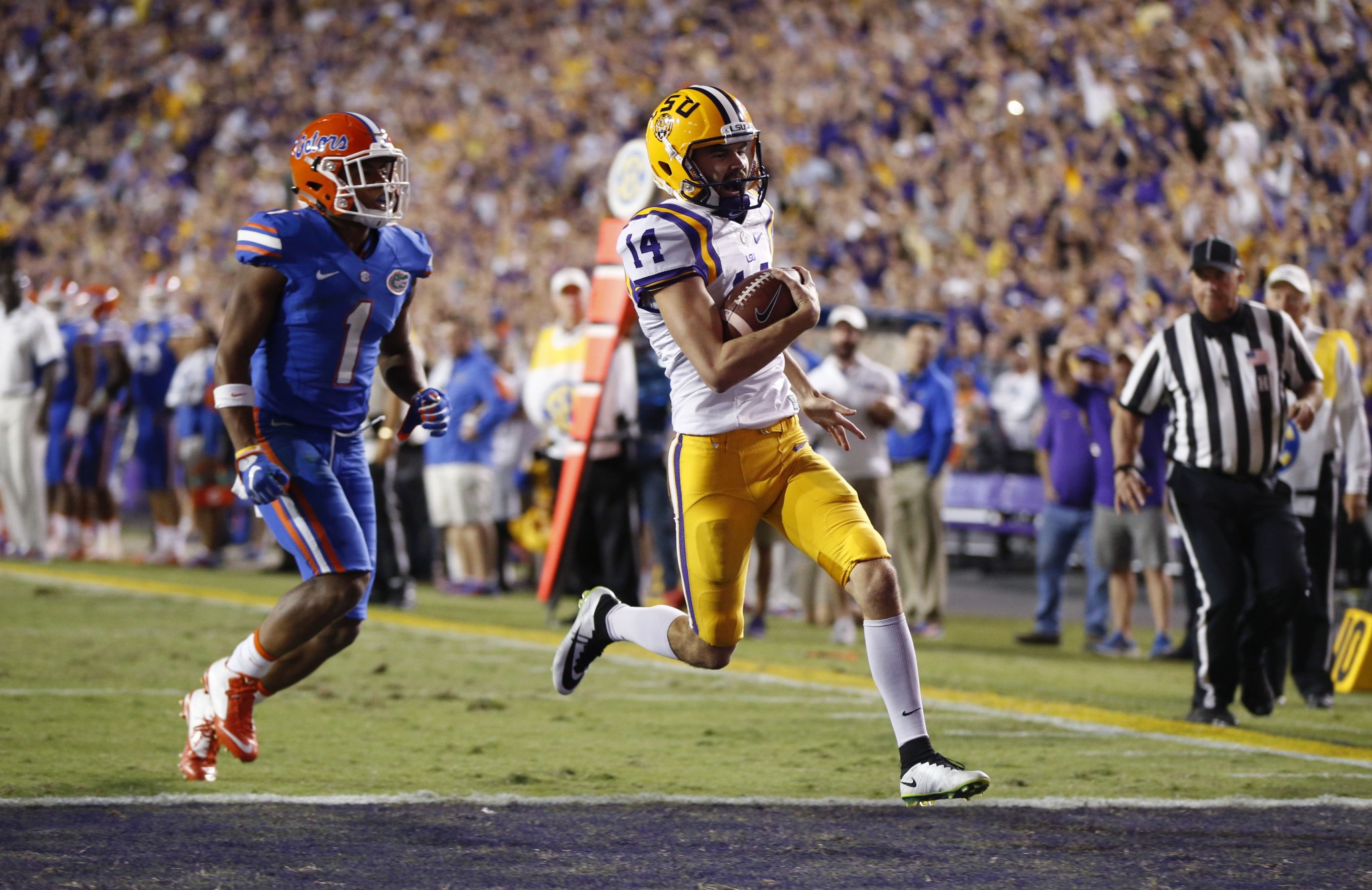 Trent Domingue (14) scored a touchdown for LSU on a fake field goal against Florida. (AP Photo/Gerald Herbert)