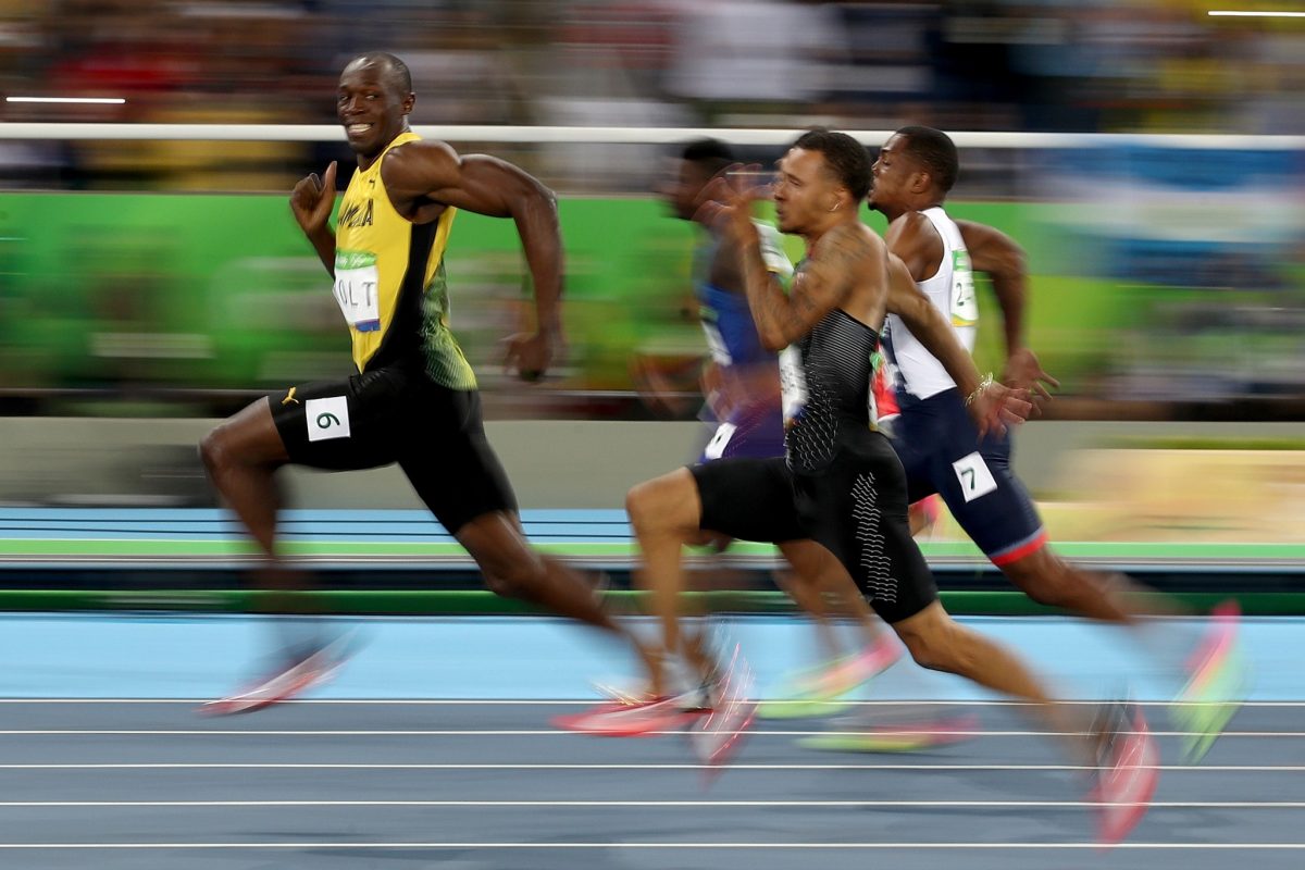 Cameron Spencer captured Usain Bolt smiling near the end of his semifinal race. Cameron Spencer/Getty Images)