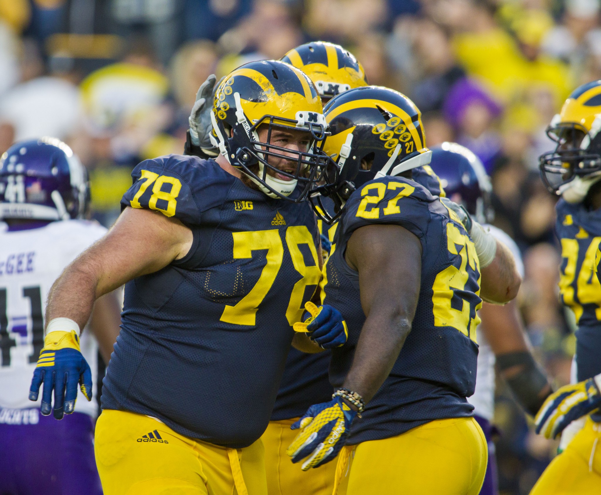 Michigan offensive lineman Erik Magnuson (78) celebrates a rushing touchdown by running back Derrick Green (27) in the fourth quarter of an NCAA college football game against Northwestern in Ann Arbor, Mich., Saturday, Oct. 10, 2015. Michigan won 38-0. (AP Photo/Tony Ding)