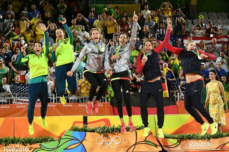 (From L to R) Brazil's silver medallists, Agatha Bednarczuk and Barbara Seixas De Freitas, Germany's gold medallists, Laura Ludwig and Kira Walkenhorst, and USA's bronze medallists, April Ross and Kerri Walsh Jennings, celebrate on the podium at the end of the women's beach volleyball event at the Beach Volley Arena in Rio de Janeiro late on August 17, 2016, during the Rio 2016 Olympic Games. / AFP / Leon NEAL (Photo credit should read LEON NEAL/AFP/Getty Images)