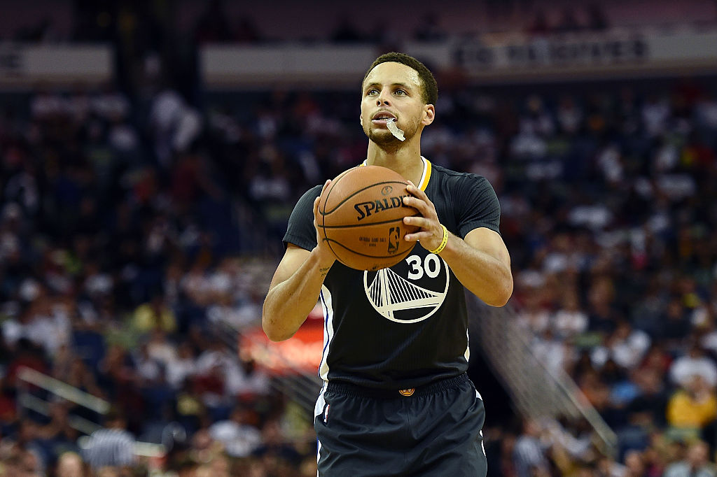 Stephen Curry exposes his mouthguard to the air, potentially damaging its resale value. (Stacy Revere/Getty Images)