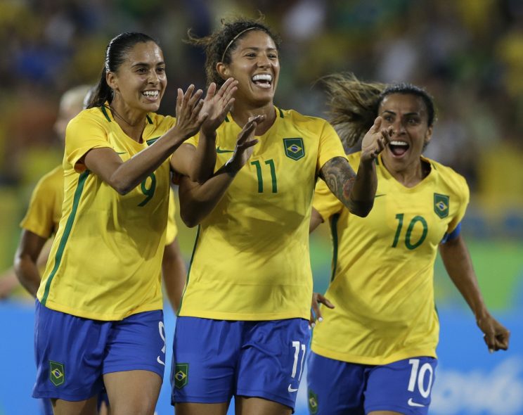 Brazil's Andressa Alves, left, Cristiane, center, and Marta celebrate after their side's second goal during a group E match of the women's Olympic football tournament between Sweden and Brazil. (AP) 