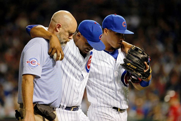 CHICAGO, IL - AUGUST 10: Pedro Strop #46 of the Chicago Cubs is helped off the field after sustaining an apparent injury while fielding a ball against the Los Angeles Angels of Anaheim by assistant trainer Ed Halbur (L) and Javier Baez #9 during the eighth inning at Wrigley Field on August 10, 2016 in Chicago, Illinois. (Photo by Jon Durr/Getty Images)