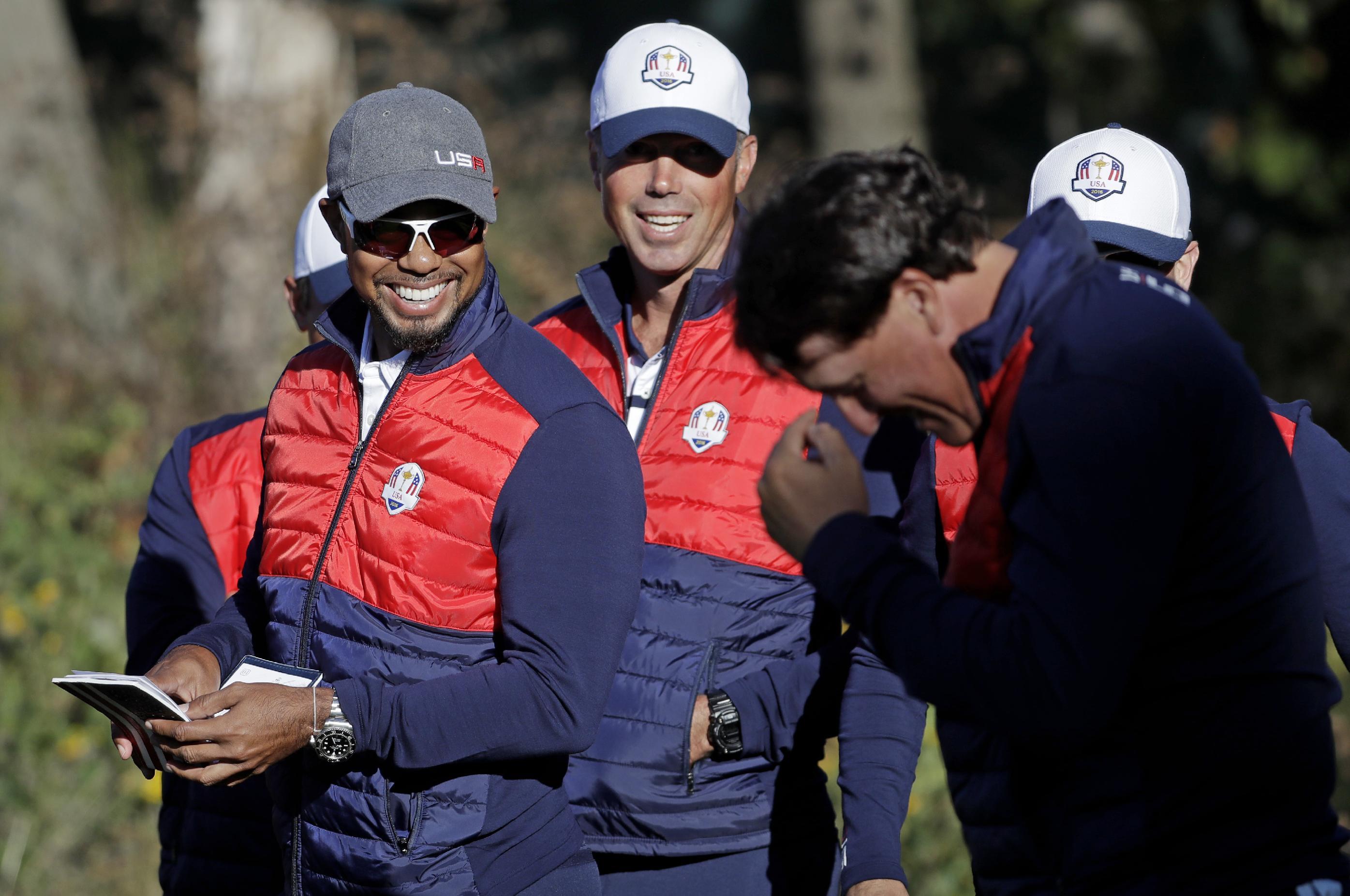 Tiger Woods, left, and Phil Mickelson, right, share a laugh in preparation for the Ryder Cup. (AP)