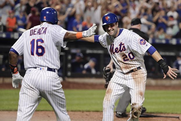 Neil Walker (20) celebrates scoring the winning run with Alejandro De Aza (16). (AP)