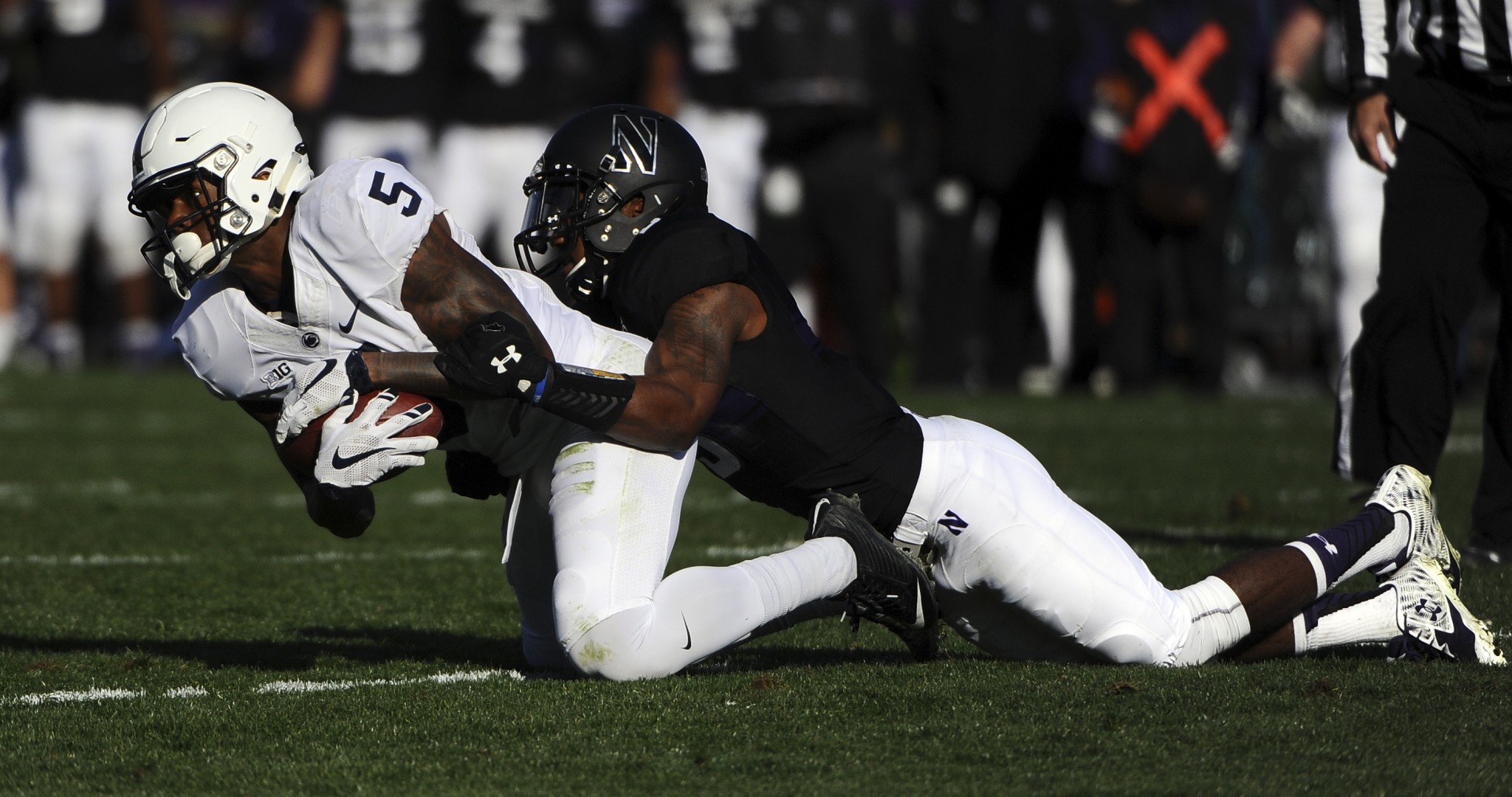 Northwestern cornerback Keith Watkins II (3) makes a tackle against Penn State. (AP Photo/Matt Marton)