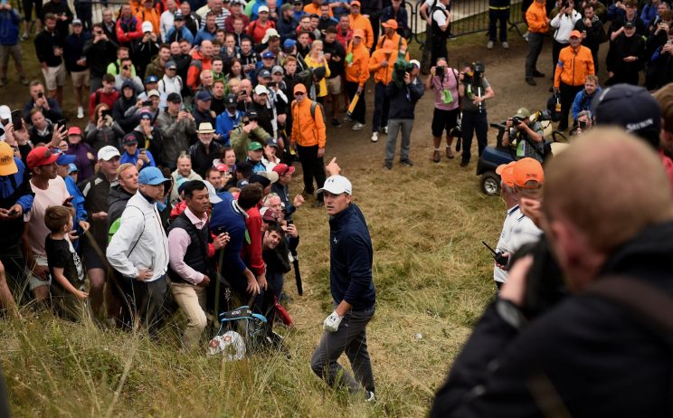 Jordan Spieth stands over his ball on a steep hill on 13. (REUTERS)