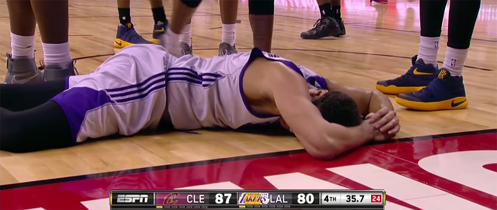 Larry Nance Jr. holds his right hand after a scary fall. (Screencap via NBA)