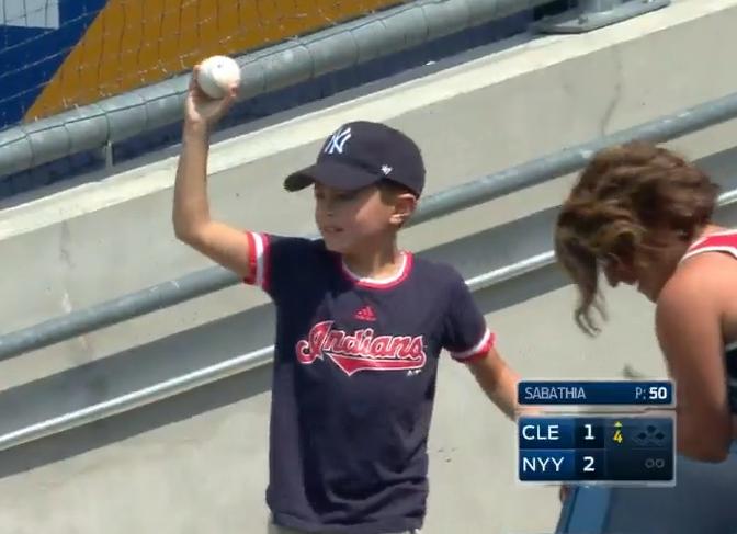 A young fan emerges from the right field bleachers at Yankee Stadium with a Jason Kipnis home run ball. (MLB screen grab)