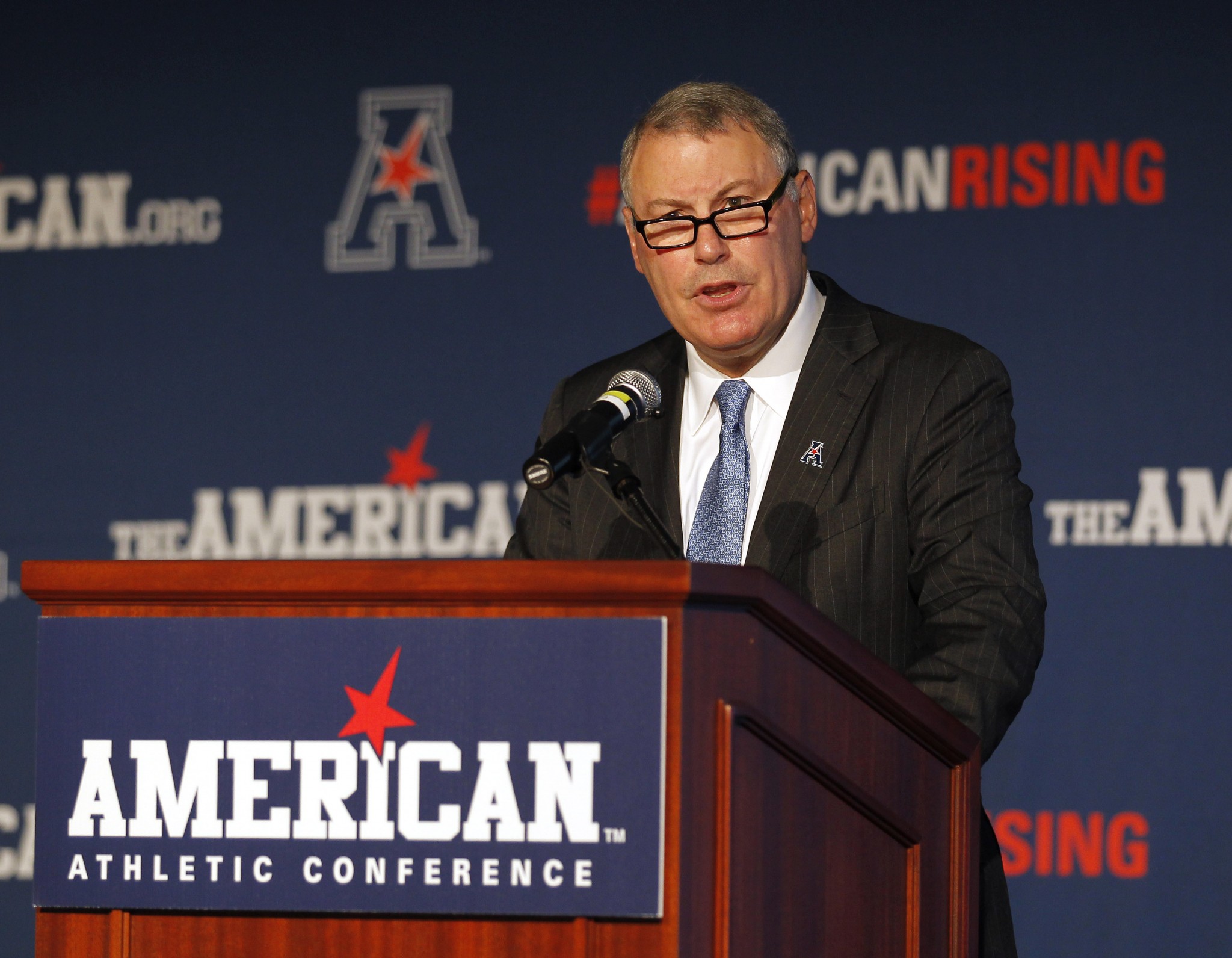 American Athletic Conference Commissioner Mike Aresco, addresses the media during an NCAA football media day in Newport, R.I., Tuesday, Aug. 4, 2015. (AP Photo/Stew Milne)