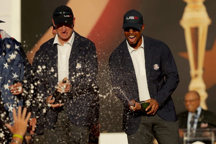 Vice-captains Jim Furyk and vice-captain Tiger Woods of the United States spray champagne after winning the Ryder Cup during the closing ceremony of the 2016 Ryder Cup at Hazeltine National Golf Club on October 2, 2016 in Chaska, Minnesota. (Photo by Streeter Lecka/Getty Images)