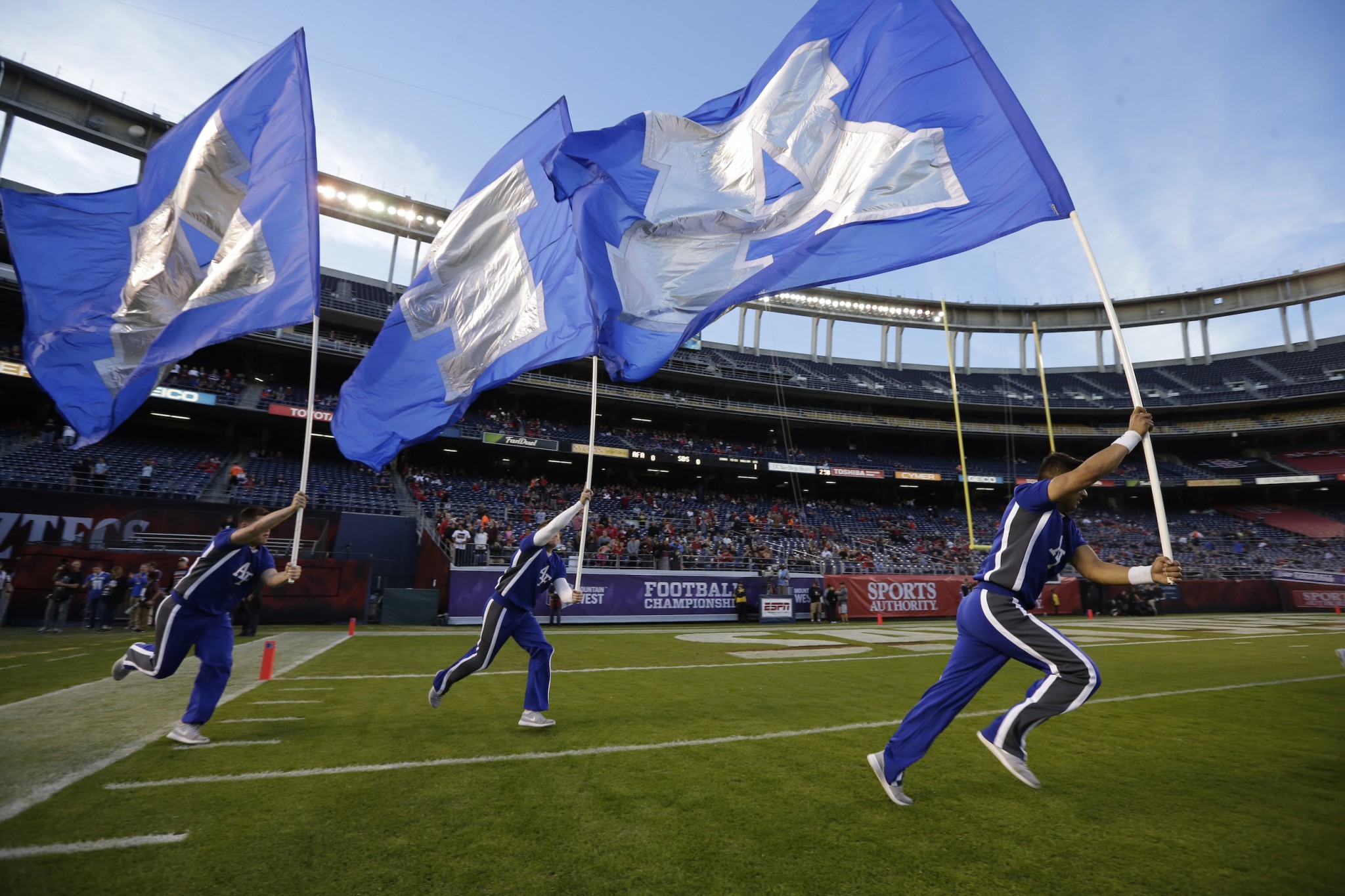 Air Force flag carriers run before the NCAA Mountain West Championship football game against San Diego State Saturday, Dec. 5, 2015, in San Diego. (AP Photo/Gregory Bull)