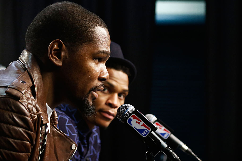 Russell Westbrook (right) listens to Kevin Durant after the Thunder beat the Warriors in Game 4 of the 2016 Western Conference Finals. (J Pat Carter/Getty Images)