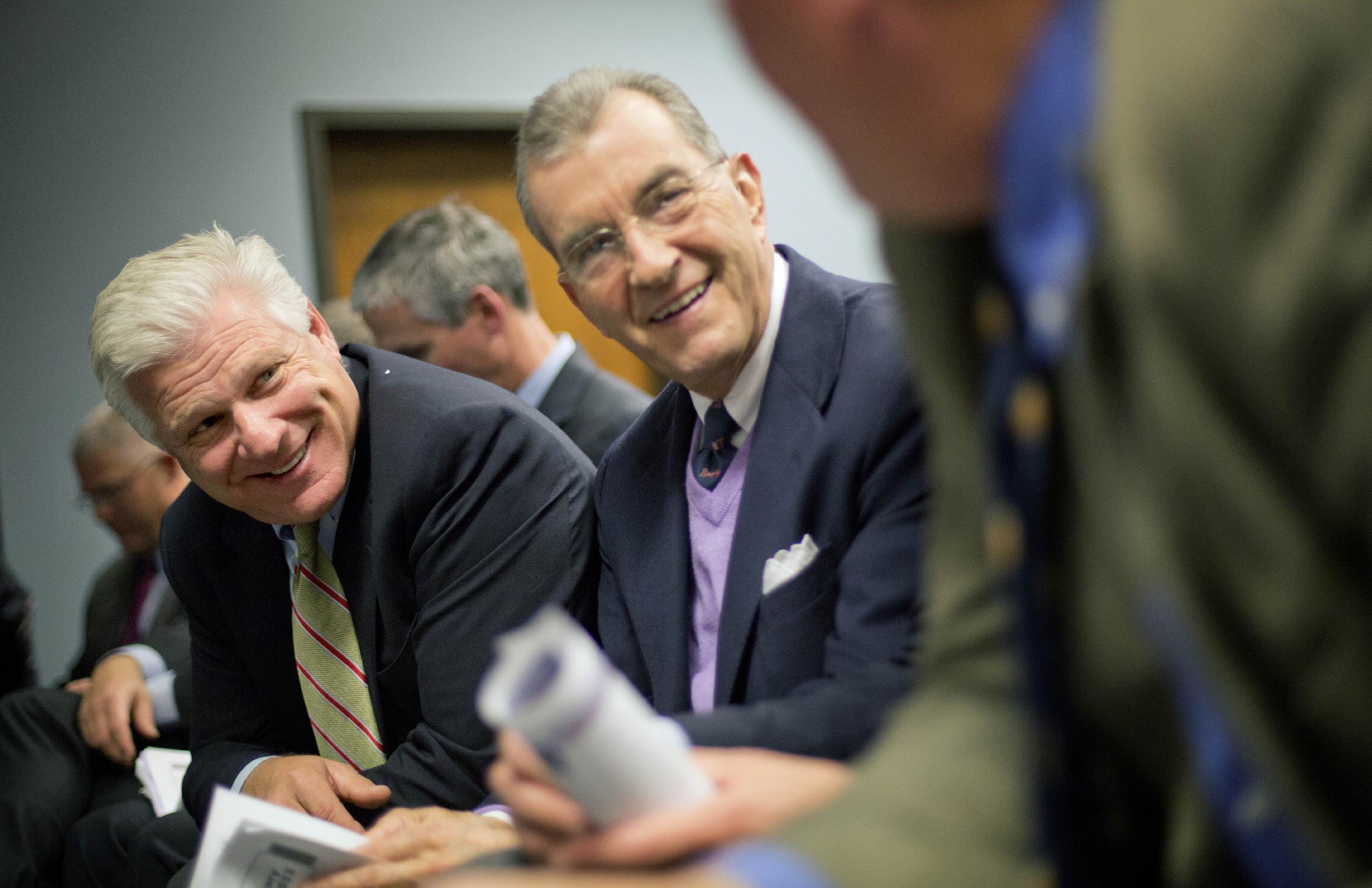 John Schuerholz (middle) before the start of a Cobb County commission hearing on a proposed plan to build the team a new baseball stadium. (AP)