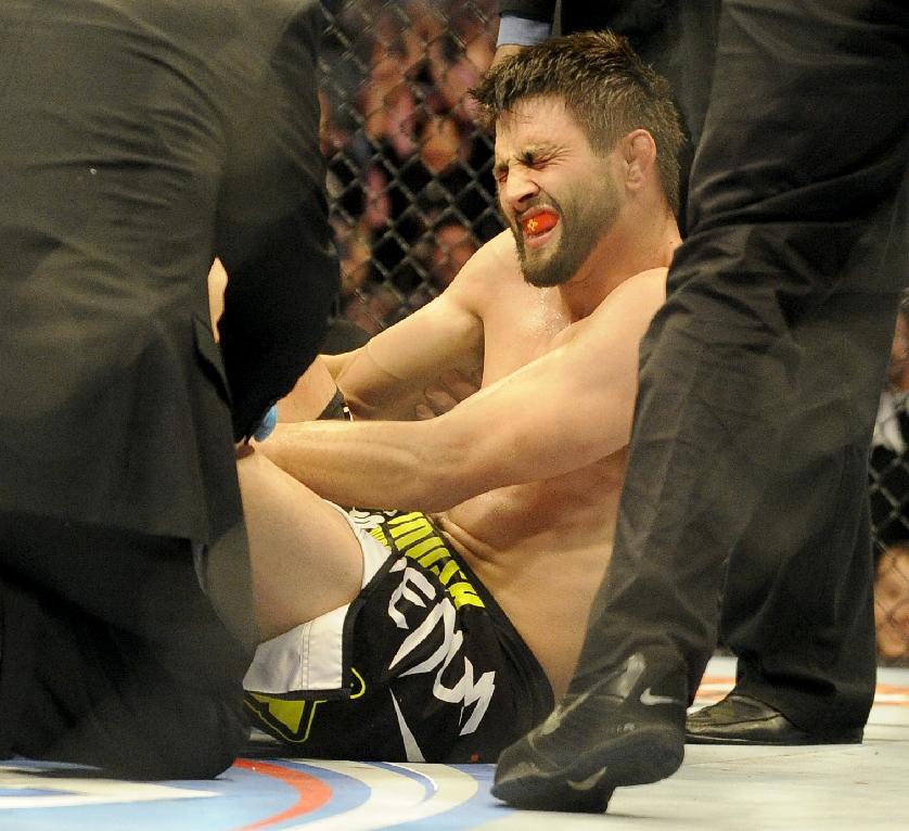 Carlos Condit is tended to by doctors after being injured during UFC 171. (AP Photo/Matt Strasen)