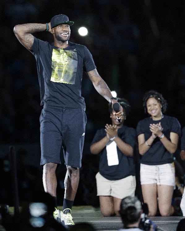 Cleveland Cavaliers' LeBron James addresses the audience at InfoCision Stadium at his homecoming  Friday, Aug. 8, 2014, in Akron, Ohio. (AP Photo/Tony Dejak)