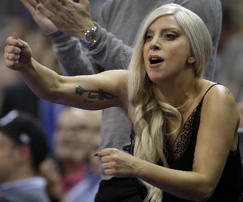 US singer Lady Gaga reacts during an NBA Global Games basketball match between US team San Antonio Spurs and German team ALBA Berlin in Berlin, Germany, Wednesday, Oct. 8, 2014. ALBA defeated San Antonio Spurs by 94-93. (AP Photo/Michael Sohn)