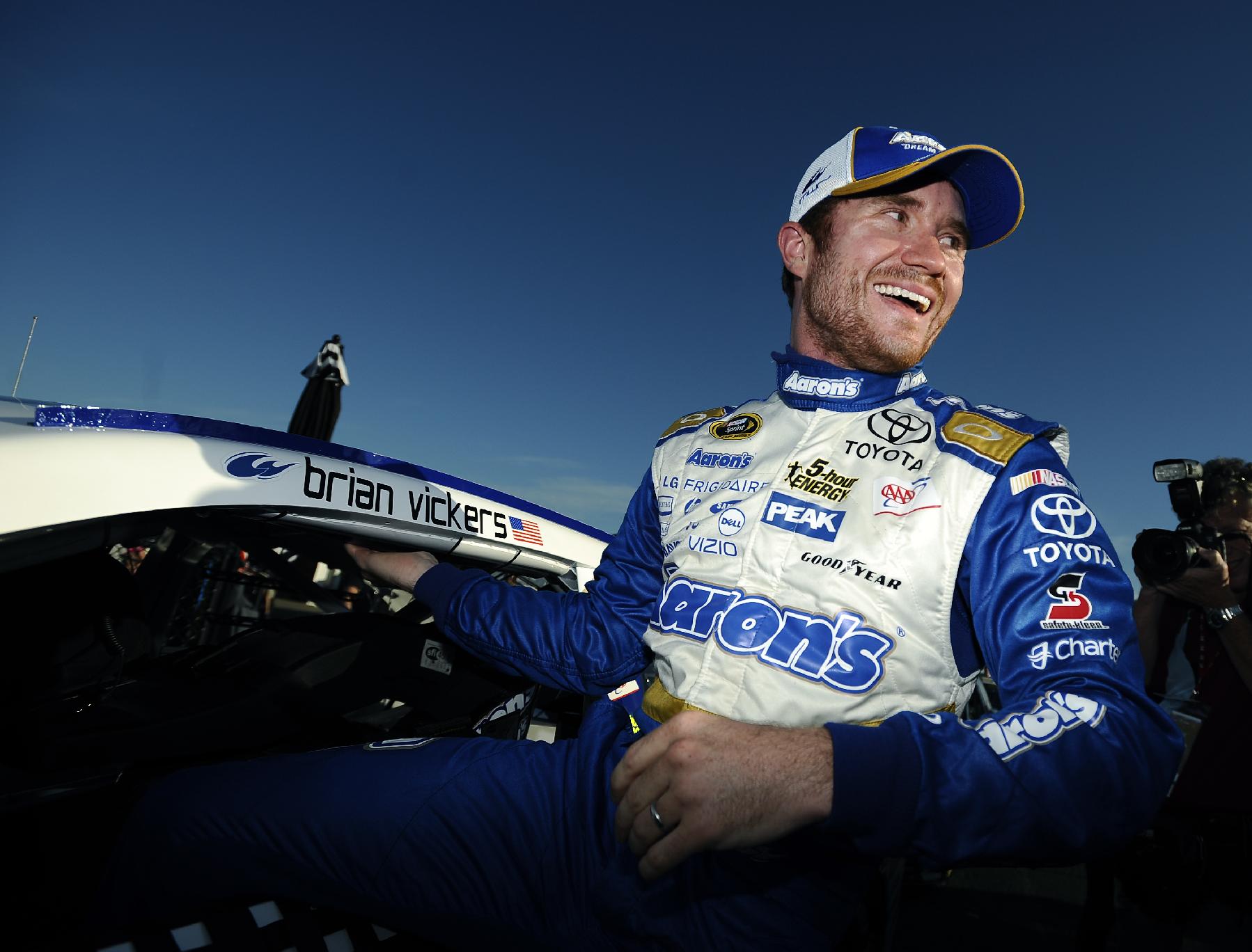 Brian Vickers climbs out of his car after winning the pole for Sunday's NASCAR Sprint Cup Series auto race at Talladega Superspeedway Saturday, Oct. 18, 2014, in Talladega, Ala.   (AP Photo/Rainier Ehrhardt)