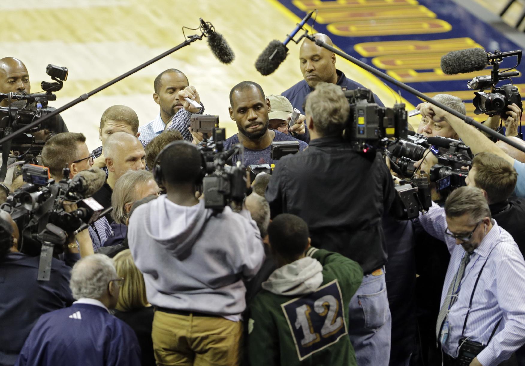 LeBron James (center) gets this sort of treatment a lot. (AP/Mark Duncan)