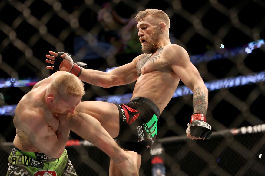 Conor McGregor, of Ireland,  lands a knee against Dennis Siver, of Germany, during their featherweight fight at UFC Fight Night, Sunday, Jan. 18, 2015 in Boston.  McGregor won via 2nd round TKO. (AP Photo/Gregory Payan)