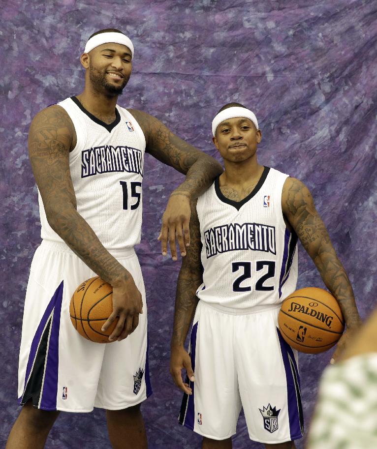 Could DeMarcus Cousins (left) and Isaiah Thomas team up once again, this time in green? (AP/Rich Pedroncelli)