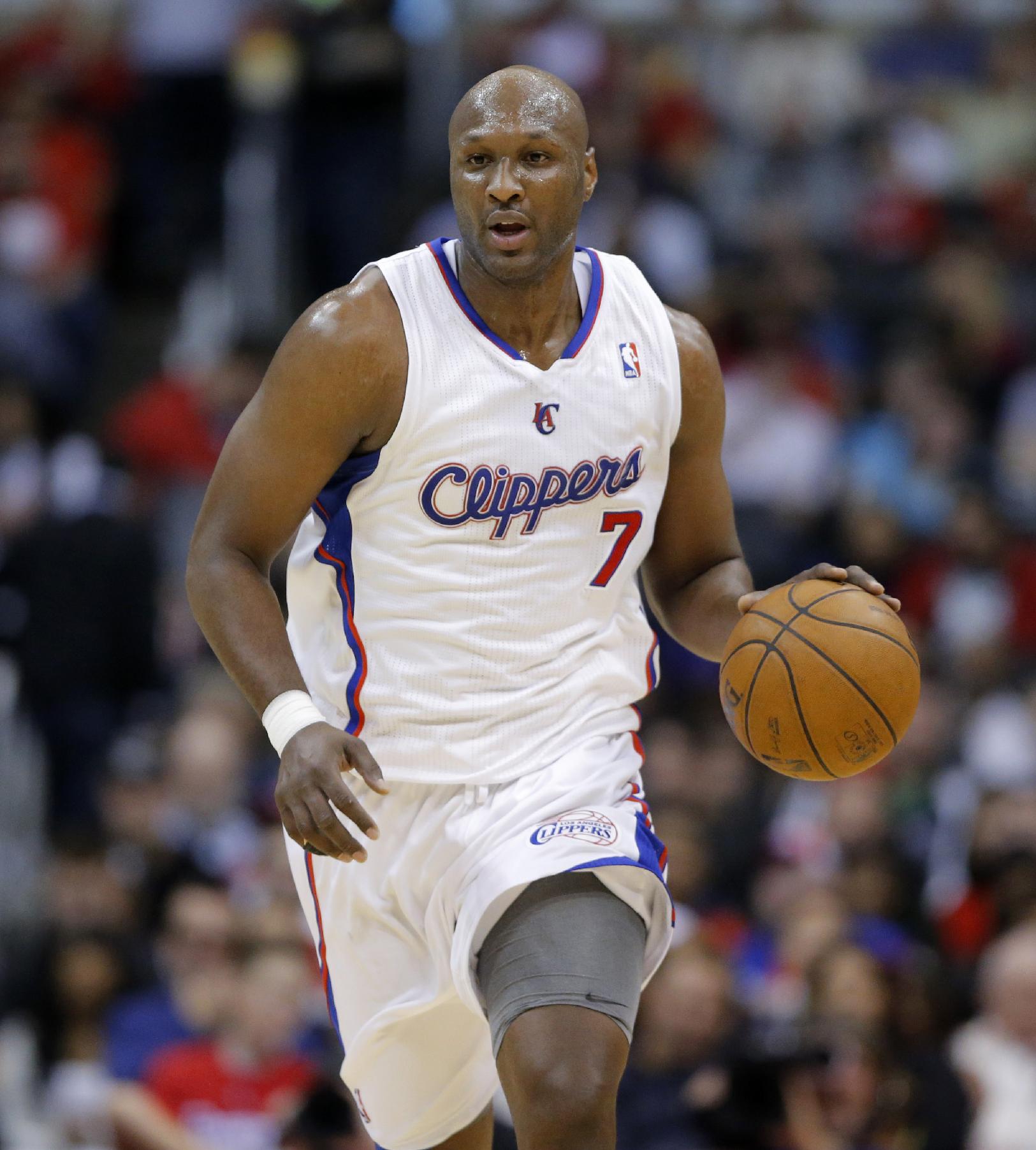 In this Dec. 8, 2012, photo, Los Angeles Clippers' Lamar Odom brings the ball up in an NBA basketball game against the Phoenix Suns in Los Angeles. The New York Knicks have signed Odom, who was out of the league this season. The move gives new president Phil Jackson an offseason to look at the versatile forward who thrived in his system. Odom helped the Los Angeles Lakers win NBA titles in 2009 and 2010, and was the Sixth Man of the Year in 2011, Jackson's final season as coach. (AP Photo/Jae C. Hong)