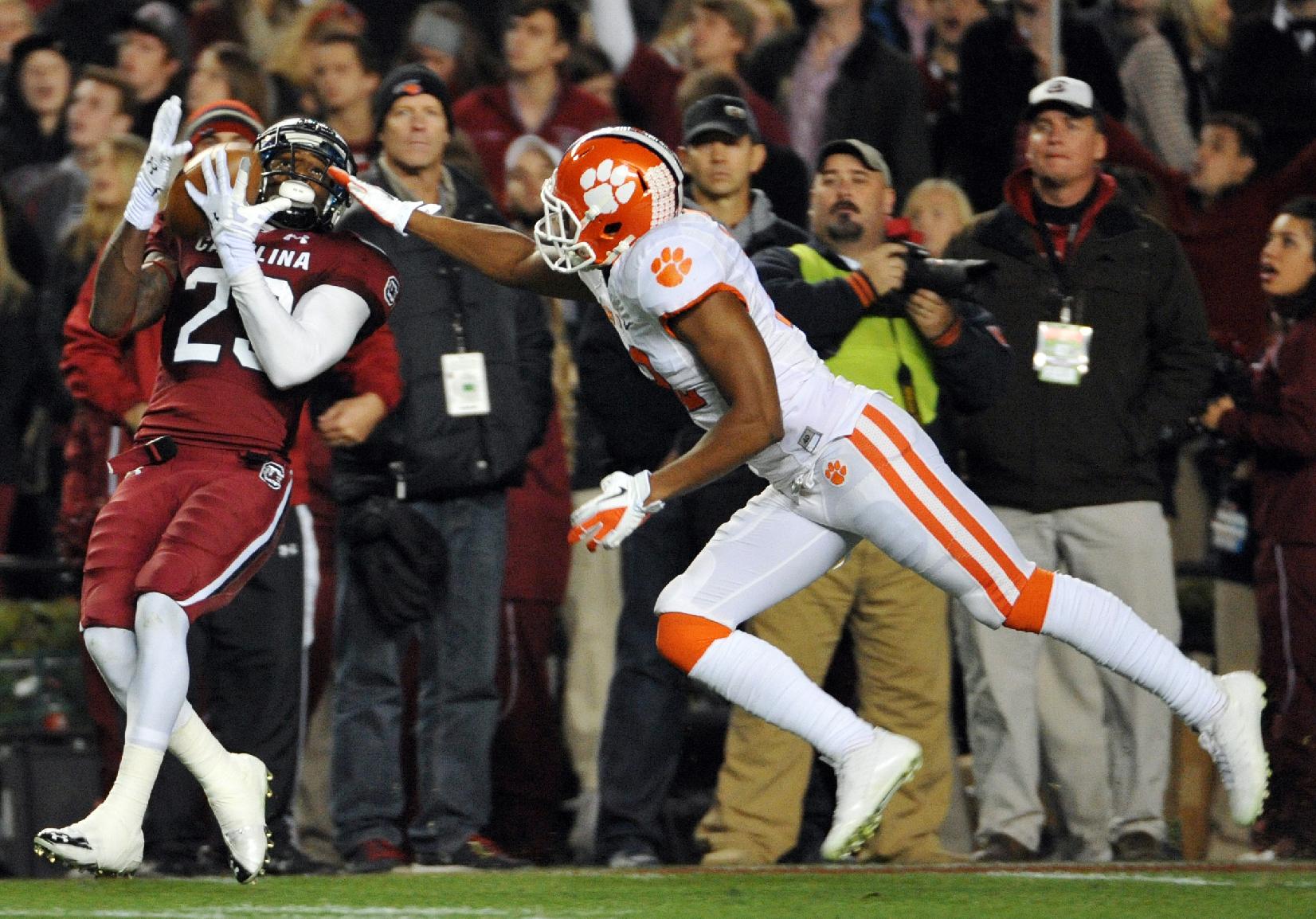 South Carolina wide receiver Bruce Ellington (23) makes a catch as Clemson safety Korrin Wiggins (12) defends during the first half of an NCAA college football game on Saturday, Nov. 30, 2013, in Columbia, S.C. (AP Photo/Rainier Ehrhardt)