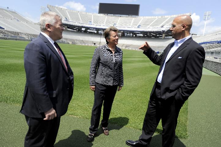 Penn State President Eric Barron, new athletic director Sandy Barbour and football coach James Franklin talk on the field of Beaver Stadium in State College, Pa. on Saturday, July 26, 2014. (AP Photo/Centre Daily Times, Christopher Weddle)