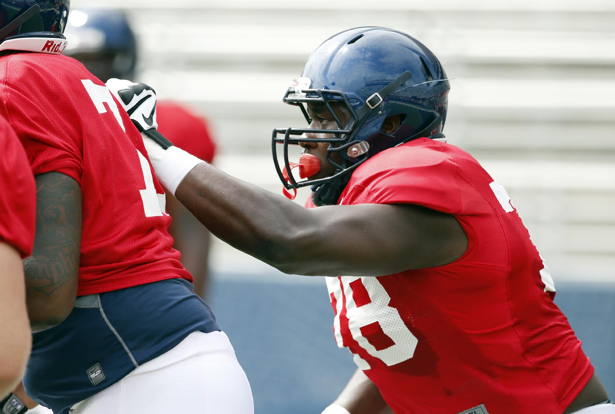 Mississippi offensive lineman Laremy Tunsil readies for a play during their final open NCAA college football practice, Saturday, Aug. 9, 2014, at Mississippi, in Oxford, Miss. Players were involved in individual and team drills. (AP Photo/Rogelio V. Solis)