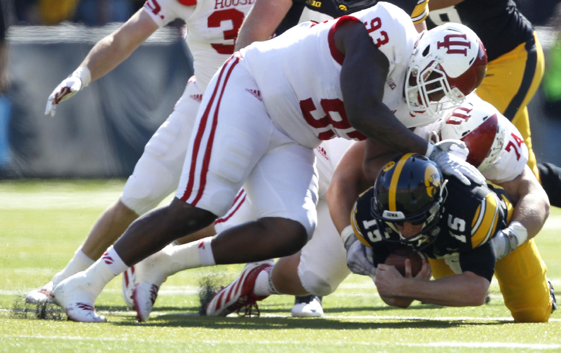 Indiana defensive tackle Ralph Green III, left, and defensive tackle Nate Hoff, right, sack Iowa quarterback Jake Rudock during the first half of an NCAA college football game Saturday, Oct. 11, 2014, in Iowa City, Iowa. (AP Photo/Matthew Putney)