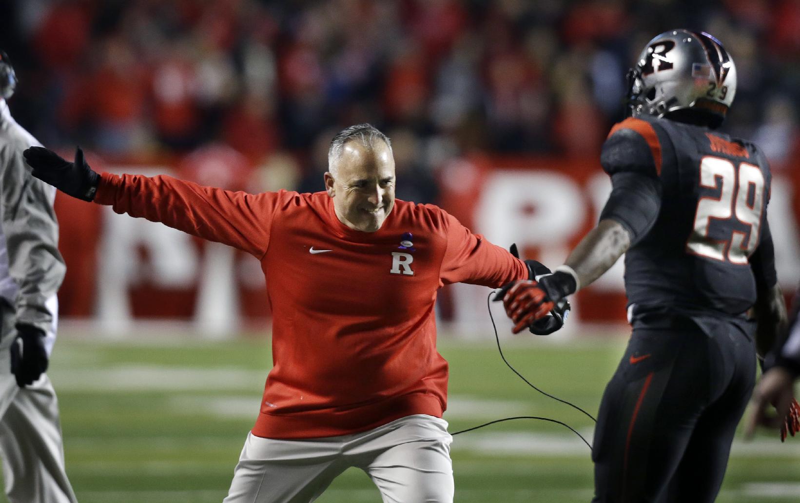 Former Rutgers coach Kyle Flood celebrates with Davon Jacobs (29) during the second half against Indiana. (AP Photo/Mel Evans)