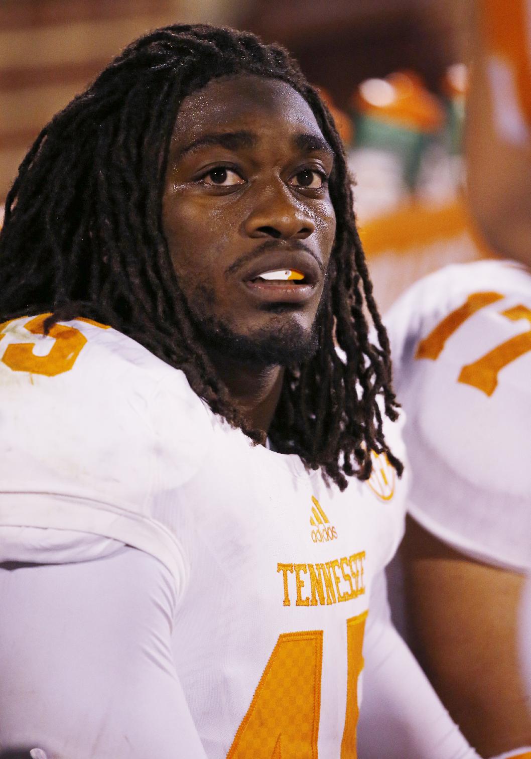 FILE - In this Sept. 13, 2014, file photo,Tennessee linebacker A.J. Johnson sits on the bench during an NCAA college football game between Tennessee and Oklahoma in Norman, Okla. Tennessee has suspended leading tackler Johnson and defensive back Michael Williams amid a sexual assault investigation. The school announced Monday, Nov. 17 on the football program's Twitter account that both players had been suspended 