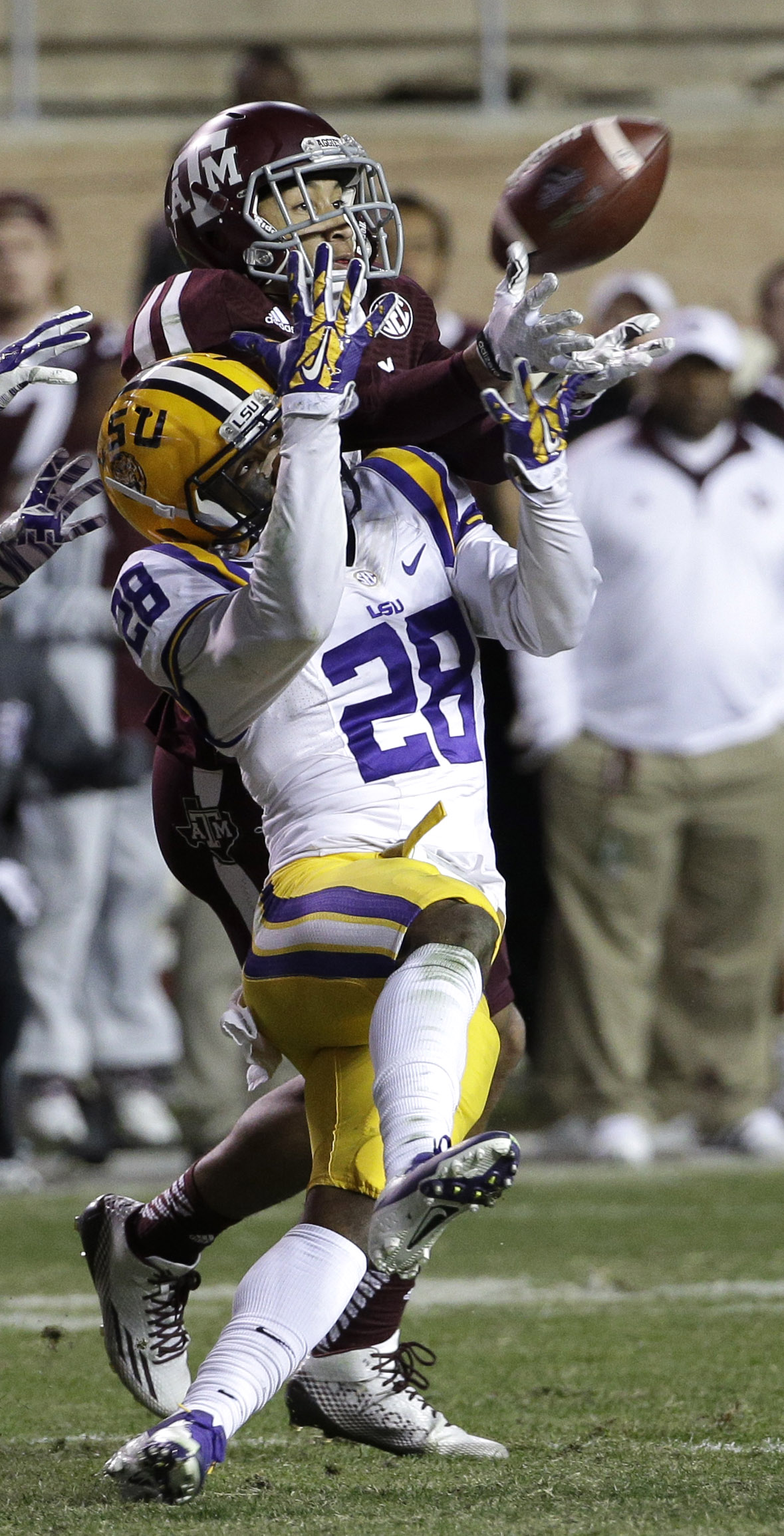 LSU safety Jalen Mills (28) breaks up a pass intended for Texas A&M wide receiver Josh Reynolds during the fourth quarter of an NCAA college football game Thursday, Nov. 27, 2014, in College Station, Texas. The pass was intercepted by LSU's Jalen Collins. LSU won 23-17. (AP Photo/David J. Phillip)