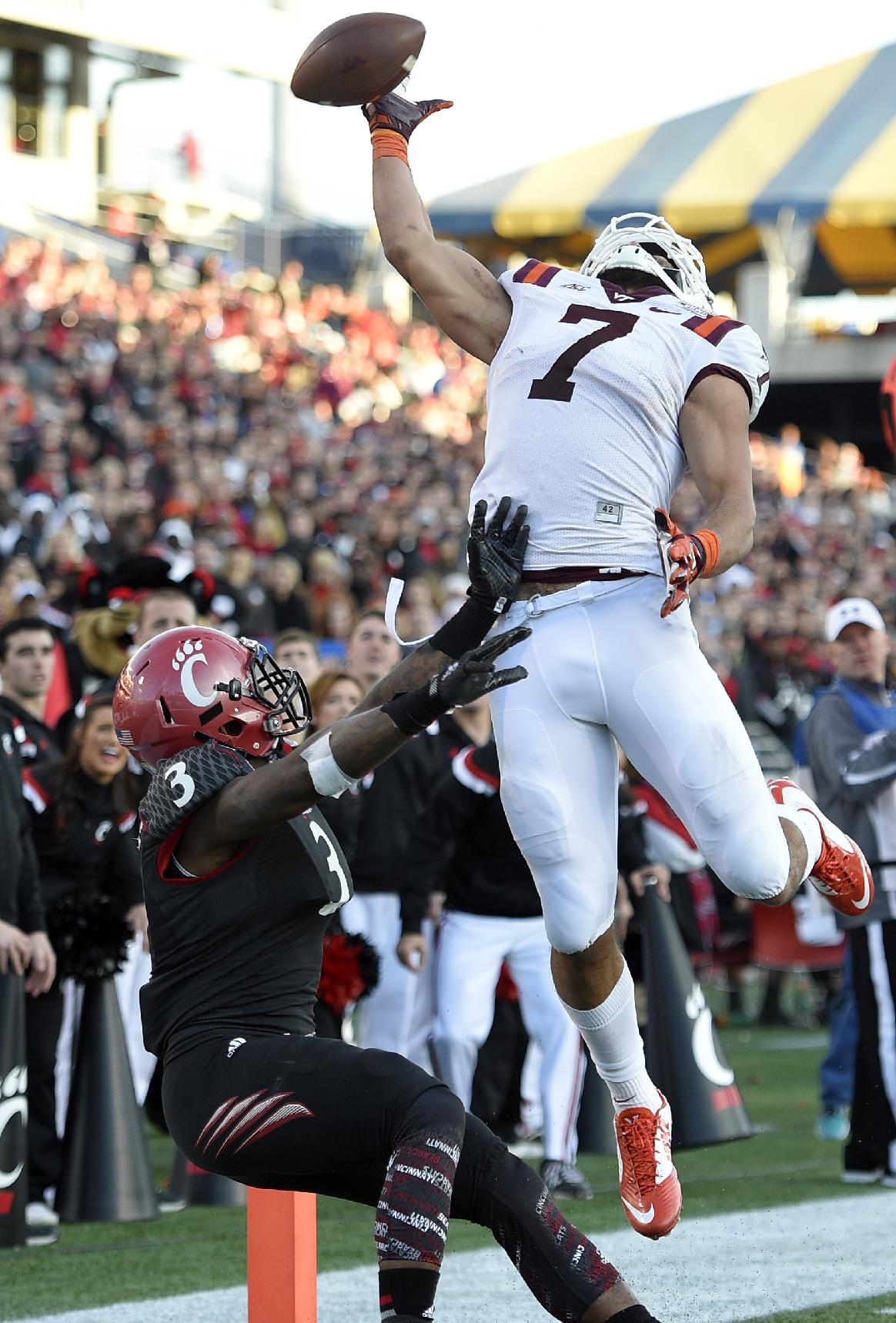 Virginia Tech tight end Bucky Hodges (7) reaches for the ball against Cincinnati defensive back Howard Wilder (3) during the second half of the Military Bowl NCAA college football game, Saturday, Dec. 27, 2014, in Annapolis, Md. The pass was incomplete. Virginia Tech won 33-17. (AP Photo/Nick Wass)