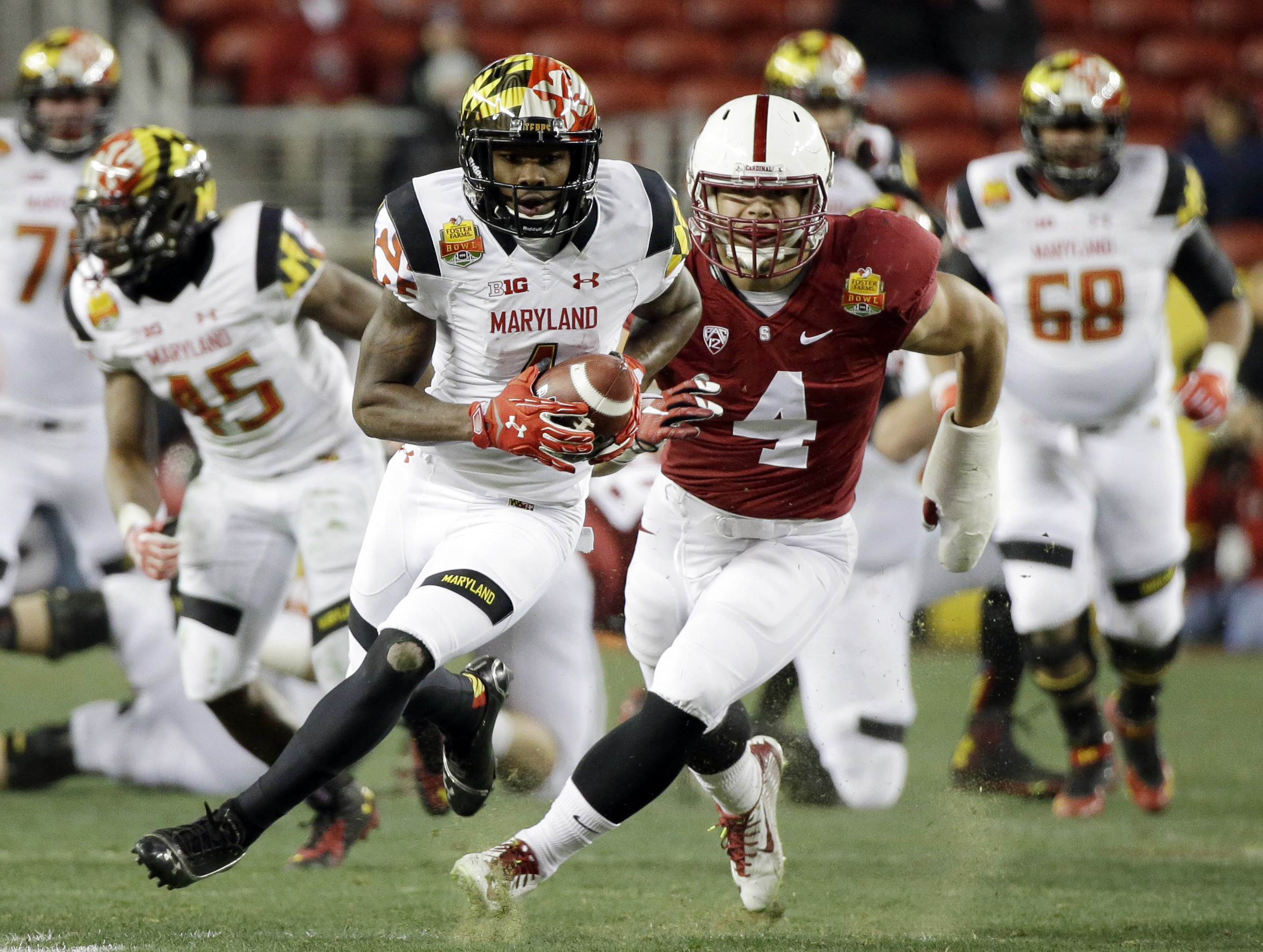 Maryland wide receiver Stefon Diggs is chased by Stanford linebacker Blake Martinez after a reception during the first half of the Foster Farms Bowl NCAA college football game Tuesday, Dec. 30, 2014, in Santa Clara, Calif. (AP Photo/Marcio Jose Sanchez)