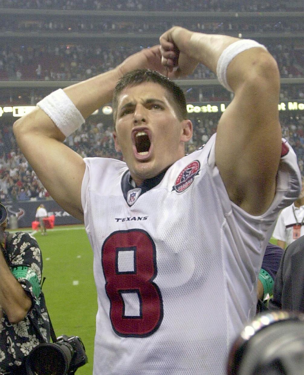 FILE - In this Sept. 8, 2002, file photo, Houston Texans quarterback David Carr celebrates the team's 19-10 win over the Dallas Cowboys in Houston. Twelve years after his brother David started the season opener as a rookie quarterback in Houston, Derek Carr will get the nod for the Oakland Raiders.  (AP Photo/Brett Coomer, File)