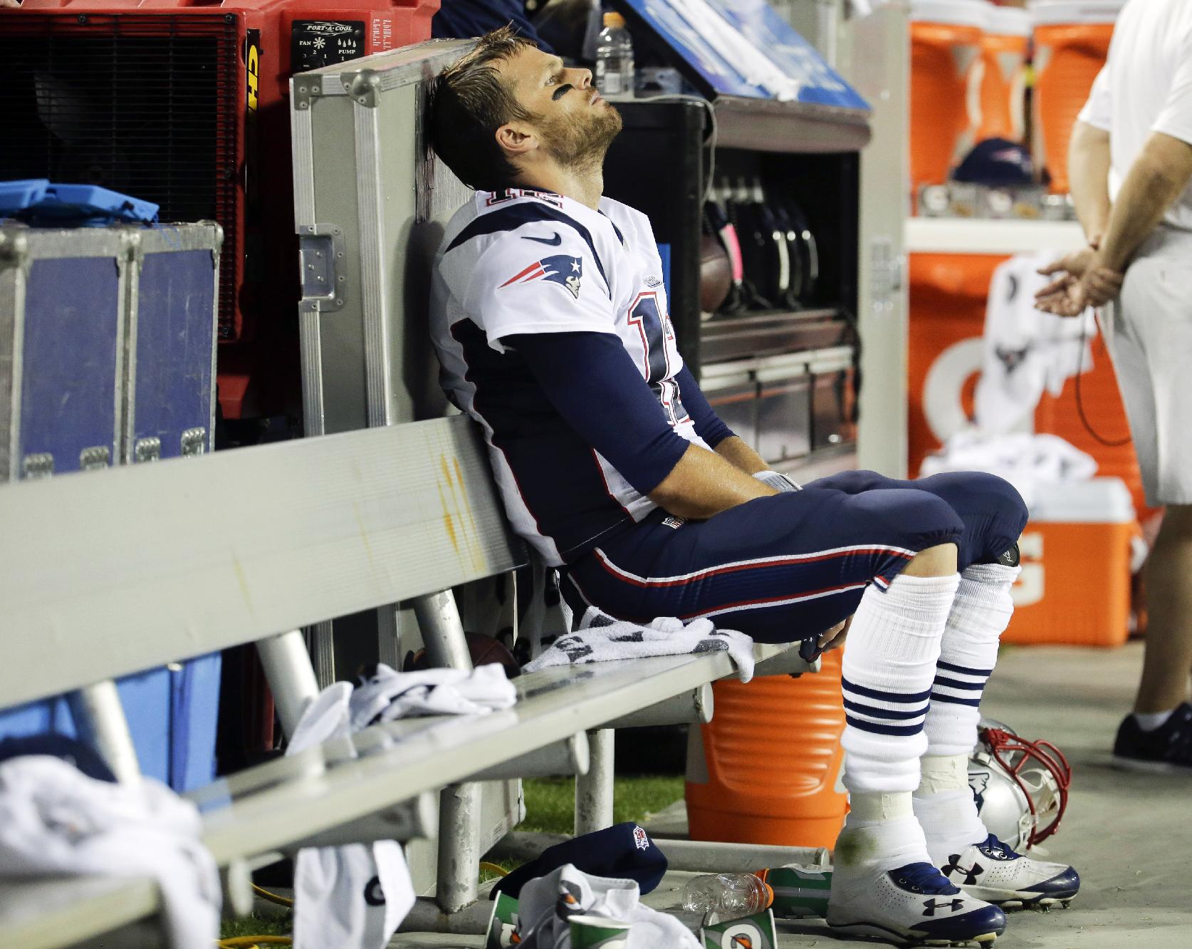 New England Patriots quarterback Tom Brady sits on the bench during the fourth quarter of an NFL football game against the Kansas City Chiefs, Monday, Sept. 29, 2014, in Kansas City, Mo. The Chiefs won 41-14. (AP Photo/Charlie Riedel)